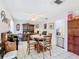 Traditional dining room with wood furniture, tiled floor and entry to an adjacent room at 711 Lake Dexter Cir, Winter Haven, FL 33884