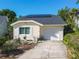Charming home with a well-maintained front yard, landscaped garden, and solar panels on roof at 711 Lake Dexter Cir, Winter Haven, FL 33884