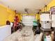 Spacious garage offering ample storage space, featuring yellow walls, white door and plenty of room for vehicles at 711 Lake Dexter Cir, Winter Haven, FL 33884
