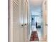 Bright hallway featuring tile flooring, multiple storage closets, and leading to a bedroom with natural light at 711 Lake Dexter Cir, Winter Haven, FL 33884