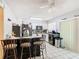 Modern kitchen with a breakfast bar, stainless steel appliances and natural light from a sliding door at 711 Lake Dexter Cir, Winter Haven, FL 33884