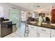 Bright kitchen showcases an island with seating overlooking dining area, with sliding door access to patio at 711 Lake Dexter Cir, Winter Haven, FL 33884