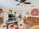 Comfortable living room with tile flooring, ceiling fan, and open layout, perfect for Gathering gatherings at 711 Lake Dexter Cir, Winter Haven, FL 33884