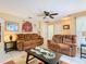 Inviting living room with neutral walls, ceiling fan, and tile flooring, creating a comfortable space at 711 Lake Dexter Cir, Winter Haven, FL 33884
