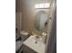 A view of the bathroom with a sink, toilet, and mirror at 730 Druid St, Lakeland, FL 33805