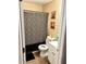 Full bathroom with a leopard print shower curtain and a white cabinet at 730 Druid St, Lakeland, FL 33805