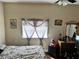 Simple bedroom with ceiling fan and window with hanging decor at 730 Druid St, Lakeland, FL 33805