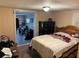 Comfortable bedroom with a large bed, wooden dresser, and view to a adjacent room at 730 Druid St, Lakeland, FL 33805