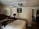 Cozy bedroom featuring warm lighting, a bed with a patterned quilt, and artwork on the wall at 730 Druid St, Lakeland, FL 33805