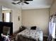 Modestly decorated bedroom with wood floors and access to another room at 730 Druid St, Lakeland, FL 33805