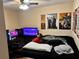 Bedroom with a black bed and a desk and computer set up with posters on the wall at 730 Druid St, Lakeland, FL 33805