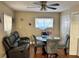 A view of the dining area with hardwood floors and a ceiling fan with a light at 730 Druid St, Lakeland, FL 33805
