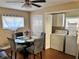 Dining room with glass table, gray chairs, and laundry appliances in a closet at 730 Druid St, Lakeland, FL 33805