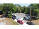 Charming single-story home with white siding, dark shutters and trim, and a concrete driveway with multiple cars parked at 730 Druid St, Lakeland, FL 33805