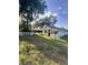 Charming single-story house featuring a white picket fence and lush green lawn and mature trees at 730 Druid St, Lakeland, FL 33805