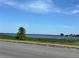 Tranquil lake view features open water and lakeside vegetation with buildings in the distance at 730 Druid St, Lakeland, FL 33805