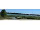 Picturesque lake view features a small dock and lush greenery with residences across the lake at 730 Druid St, Lakeland, FL 33805
