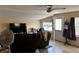 Bright living room featuring tile floors, large windows, a ceiling fan, and comfortable seating at 730 Druid St, Lakeland, FL 33805