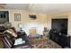 Inviting living room with a comfortable leather couch, patterned rug, and entertainment center with TV at 730 Druid St, Lakeland, FL 33805
