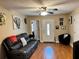 Inviting living room featuring sleek furniture, including a comfortable leather couch, a ceiling fan, and modern decor at 730 Druid St, Lakeland, FL 33805
