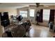 Bright living room featuring tile floors, large windows, a ceiling fan, and comfortable seating at 730 Druid St, Lakeland, FL 33805