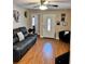 Inviting living room featuring sleek furniture, including a comfortable leather couch, a ceiling fan, and modern decor at 730 Druid St, Lakeland, FL 33805
