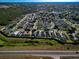 Aerial view of a well-planned community featuring neatly arranged homes and a beautiful neighborhood layout at 8001 Arrow Creek Rd, Kissimmee, FL 34747