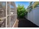 Enclosed backyard with decorative brown mulch and a screened-in patio offers a cozy outdoor space at 8001 Arrow Creek Rd, Kissimmee, FL 34747