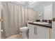 Bathroom featuring a single vanity, toilet, and a shower/tub combo with a striped curtain at 8001 Arrow Creek Rd, Kissimmee, FL 34747