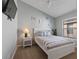 Cozy bedroom featuring a white bed frame, nautical decor, and natural light from the window at 8001 Arrow Creek Rd, Kissimmee, FL 34747