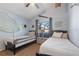 Charming bedroom with twin beds, nautical decor, and a window overlooking the pool area at 8001 Arrow Creek Rd, Kissimmee, FL 34747