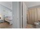 Cozy bedroom with neutral tones and an attached bathroom provides a private retreat at 8001 Arrow Creek Rd, Kissimmee, FL 34747