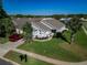 Charming single-story home with a well-manicured lawn, mature palm trees, and a cozy front entrance at 8001 Arrow Creek Rd, Kissimmee, FL 34747
