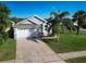 Charming home with a two-car garage and a well-maintained lawn, offering curb appeal and practicality at 8001 Arrow Creek Rd, Kissimmee, FL 34747