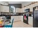 Modern kitchen featuring white cabinetry, black appliances, and sleek countertops at 8001 Arrow Creek Rd, Kissimmee, FL 34747