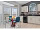 Bright kitchen with white cabinets, black appliances, and a charming breakfast nook with natural light at 8001 Arrow Creek Rd, Kissimmee, FL 34747