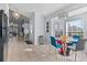 Open-concept kitchen and dining area with tile floors, white cabinets, and modern appliances at 8001 Arrow Creek Rd, Kissimmee, FL 34747