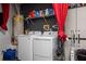 Efficient laundry area with washer, dryer, storage cabinets, and a hot water tank at 8001 Arrow Creek Rd, Kissimmee, FL 34747