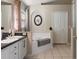 Bright main bathroom featuring a soaking tub and elegant fixtures ensures a luxurious experience at 8001 Arrow Creek Rd, Kissimmee, FL 34747