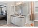 Bright main bathroom with dual sinks and a soaking tub offers comfort and style at 8001 Arrow Creek Rd, Kissimmee, FL 34747