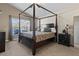 Well-lit main bedroom with a four-poster bed and an airy ambiance creates a relaxing retreat at 8001 Arrow Creek Rd, Kissimmee, FL 34747