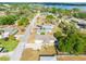 Aerial view of a home showcasing its location within a residential neighborhood and near a lake at 806 Avenue G Ne, Winter Haven, FL 33881