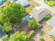 Aerial view of a home's spacious backyard, featuring a patio area and mature trees at 806 Avenue G Ne, Winter Haven, FL 33881