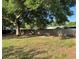 Fenced backyard featuring mature tree and ample space for outdoor activities and entertaining at 806 Avenue G Ne, Winter Haven, FL 33881