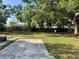 Spacious backyard with patio and large tree, perfect for enjoying the outdoors at 806 Avenue G Ne, Winter Haven, FL 33881