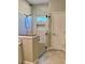 Modern bathroom with a large frameless shower, tiled walls, and a neutral color scheme at 806 Avenue G Ne, Winter Haven, FL 33881