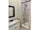 Bathroom featuring shower and tub with tile walls, rainfall shower head, and modern vanity at 806 Avenue G Ne, Winter Haven, FL 33881