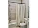 Bathroom featuring shower and tub with tile walls, rainfall shower head, and white cabinets at 806 Avenue G Ne, Winter Haven, FL 33881