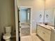 Open view from a bathroom to a bedroom with neutral tones and natural light at 806 Avenue G Ne, Winter Haven, FL 33881
