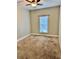 Bedroom featuring neutral carpet, ceiling fan, window, and neutral colored walls at 806 Avenue G Ne, Winter Haven, FL 33881